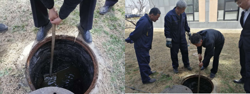 明洁物业工程主管带领着员工疏通下水道