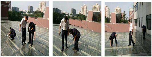 图为郭泗淳和同事玻璃顶打胶